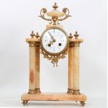 An early 20th century French pink marble and brass mantle clock, circa 1900-10, with brass mounted