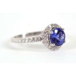An 18ct white gold, diamond and tanzanite cluster ring, with diamond set open shank.