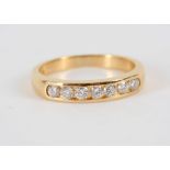 An 18ct yellow gold, 7 stone channel set ring.