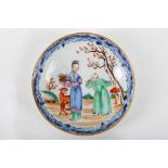 A Chinese famille rose and underglaze blue decorated dish with a scene of a lady with a deer, Qing