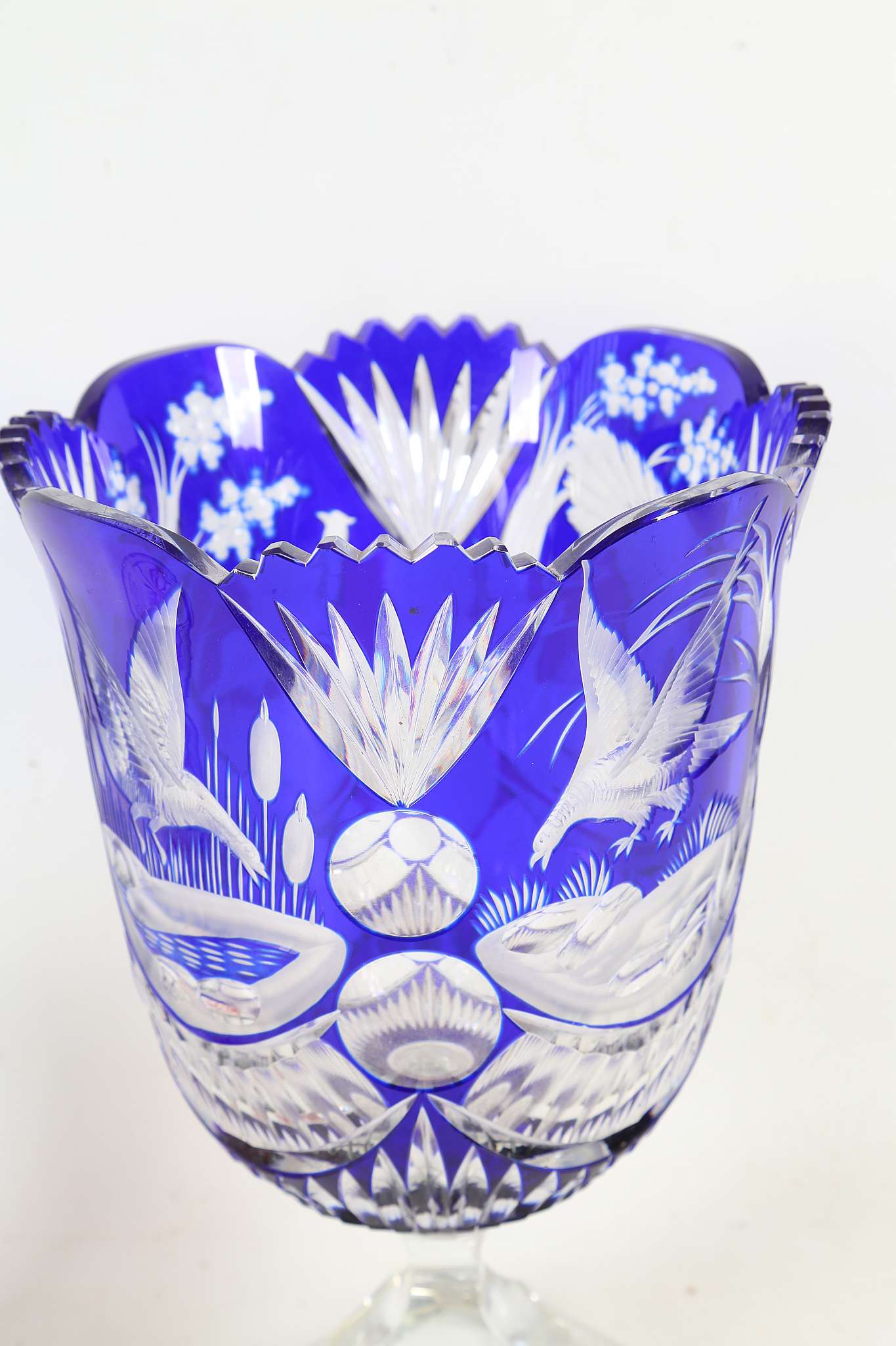 A Bohemian blue overlaid glass vase, decorated with diving birds among bullrushes, on canted - Image 2 of 3