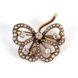 A late Victorian yellow gold, diamond set tied bow brooch.