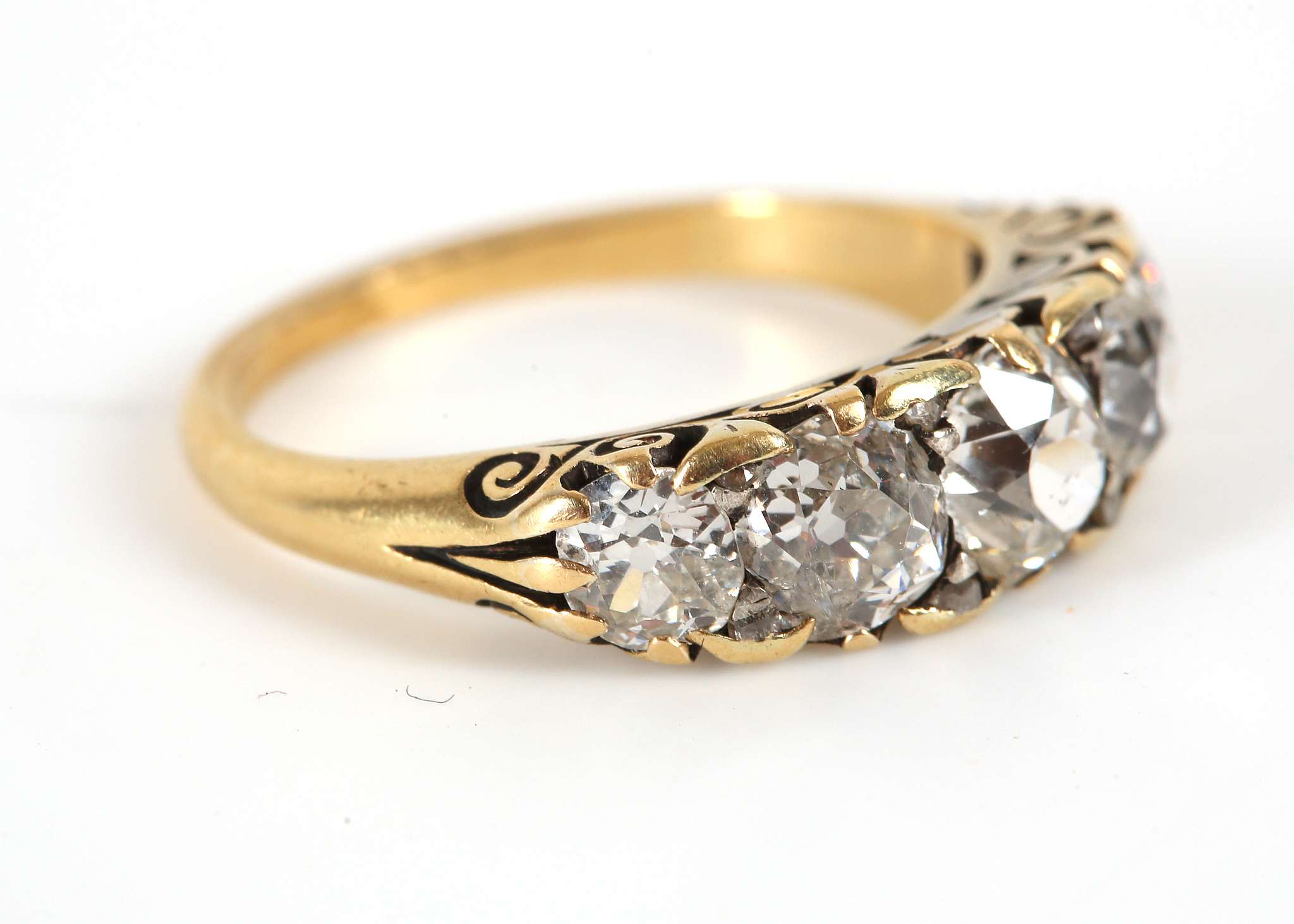 A yellow gold, diamond five stone graduated ring, claw set in a Victorian style open scroll mount. - Image 2 of 3