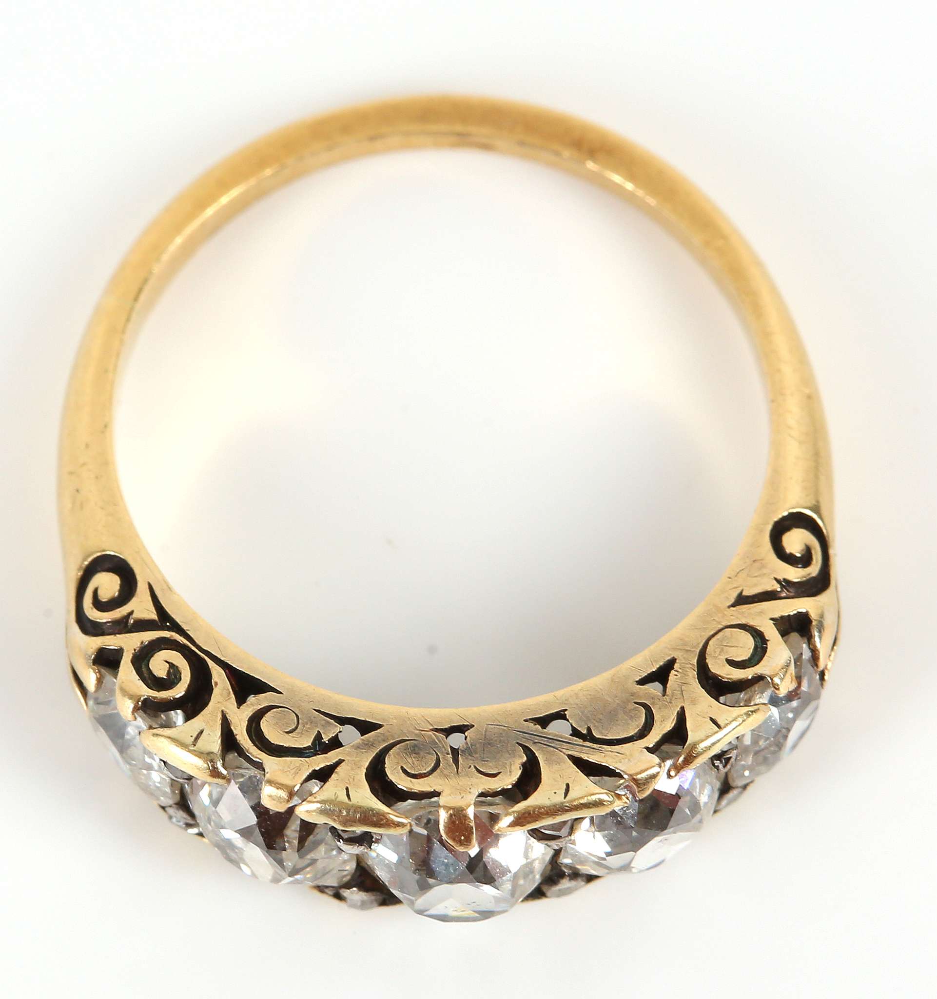 A yellow gold, diamond five stone graduated ring, claw set in a Victorian style open scroll mount. - Image 3 of 3