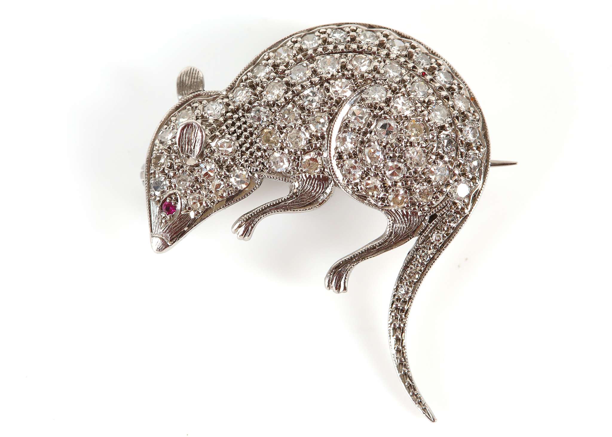 An unusual white gold, diamond set brooch modelled as a rat with ruby eye.
