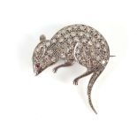 An unusual white gold, diamond set brooch modelled as a rat with ruby eye.