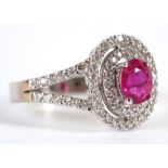 An 18ct white gold, pink sapphire and diamond cluster ring, with diamond set open shoulder.
