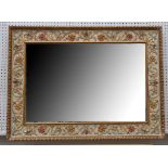 A contemporary rectangular polychrome wall mirror, with floral vineous border, 126 x 92m.