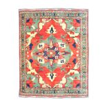 A FINE UZBEKISTAN CARPET approx: 11ft.3in. x 9ft.8in.(342cm. x 294cm.) The soft light red field with