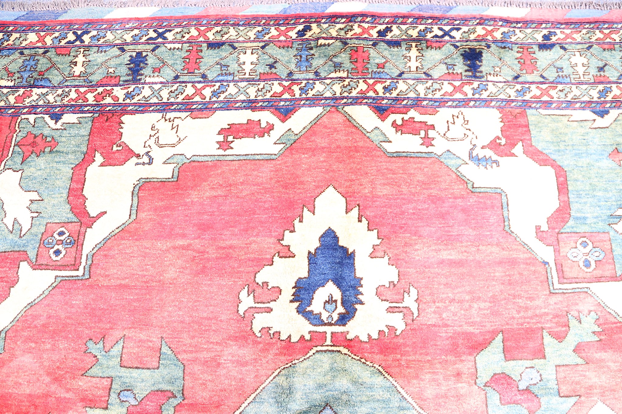 A FINE UZBEKISTAN CARPET approx: 11ft.3in. x 9ft.8in.(342cm. x 294cm.) The soft light red field with - Image 4 of 5