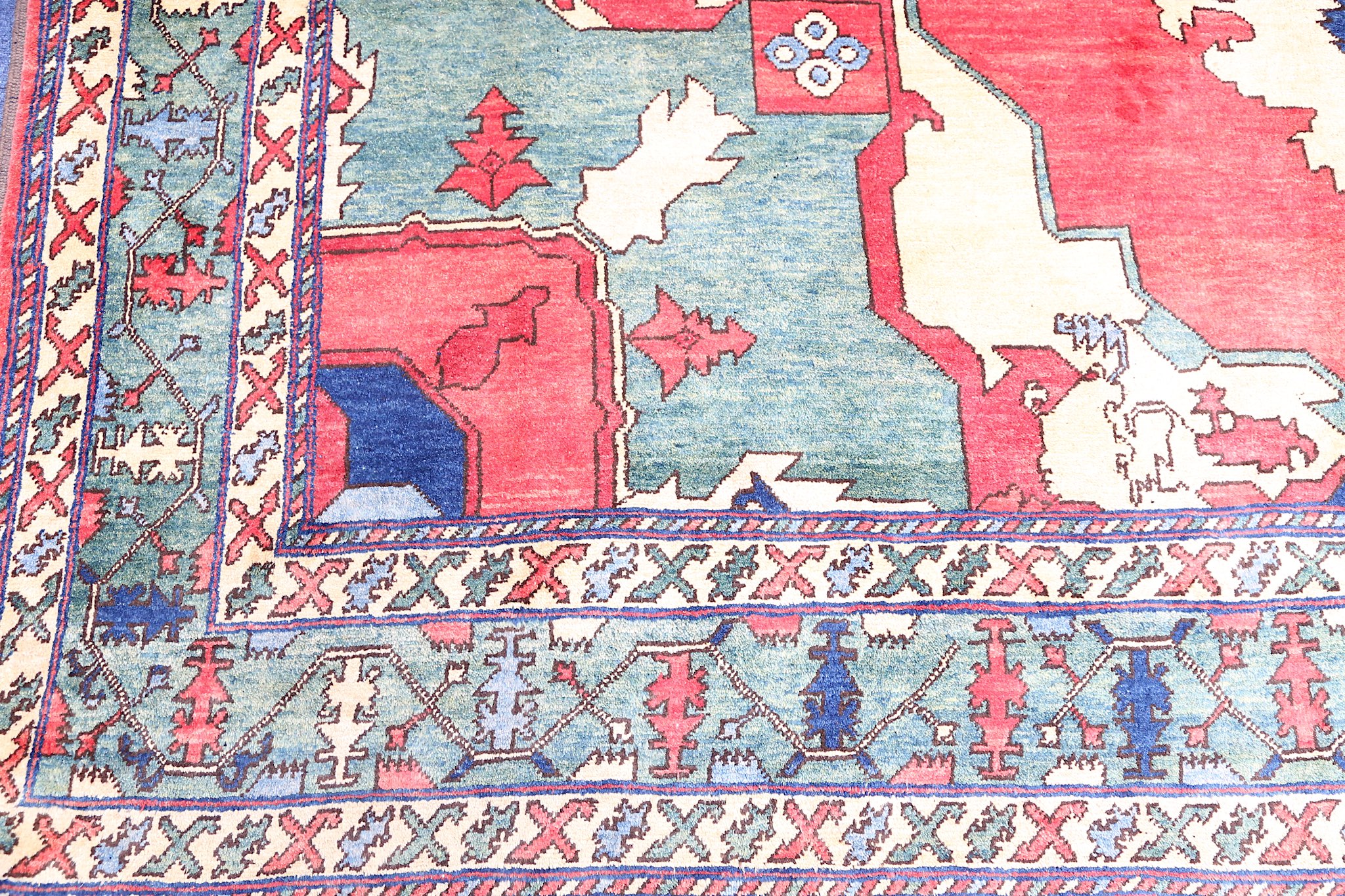 A FINE UZBEKISTAN CARPET approx: 11ft.3in. x 9ft.8in.(342cm. x 294cm.) The soft light red field with - Image 2 of 5