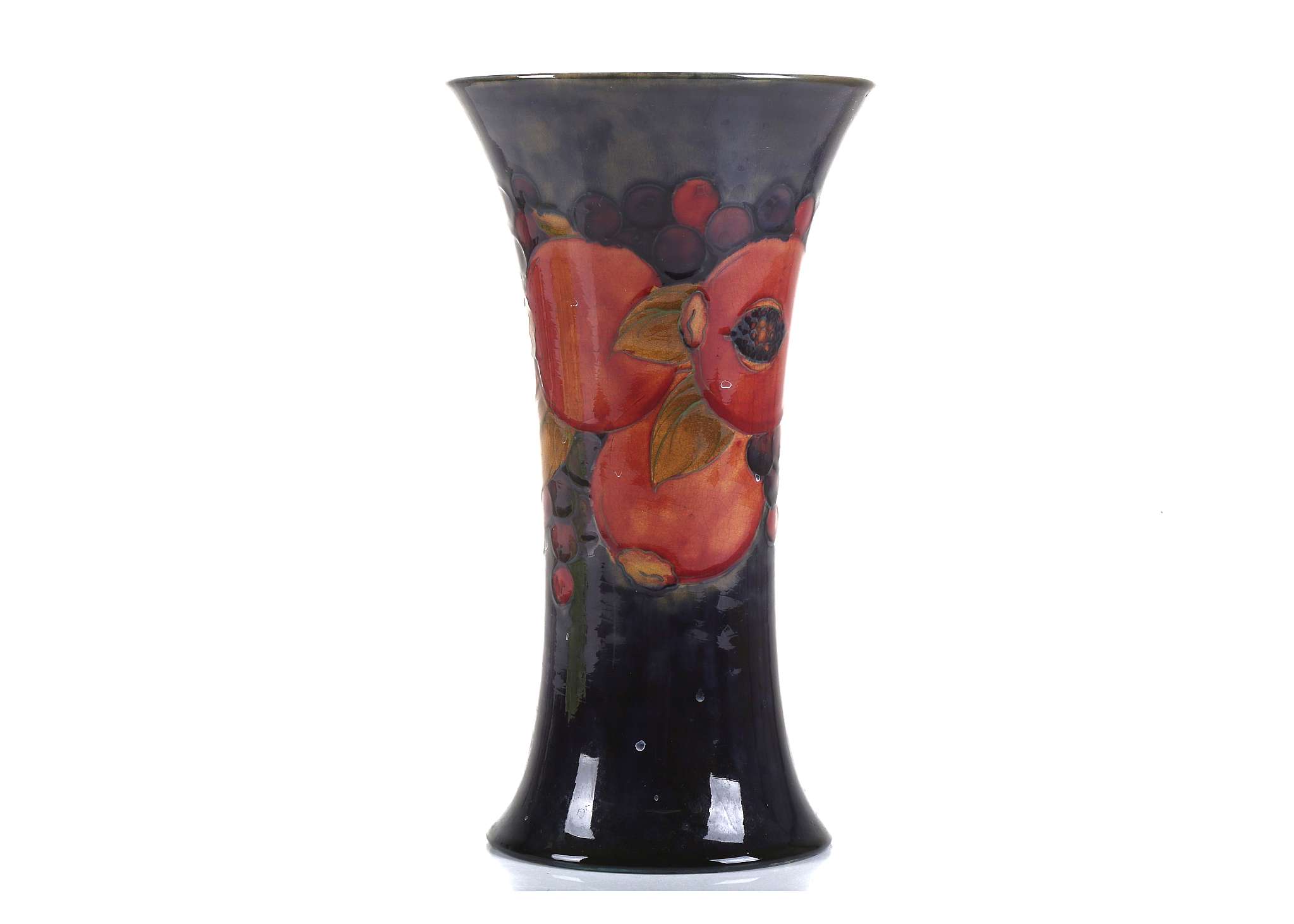 A WILLIAM MOORCROFT POTTERY VASE OF OVOID FROM, tube-lined with pomegranate and berry's, with