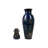 ELTON, Circa 1900, a large baluster shaped vase with mottled blue glaze and decorated with a band of