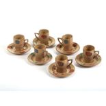 AN UNUSUAL SET OF SIX COFFEE CUPS AND SAUCERS BY CLARICE CLIFF IN BIZZARE, made of salt-glaze