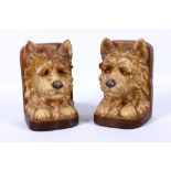 Compton pottery, a pair of unusual book-ends modelled as dogs, in light brown semi-matt glazes, c.