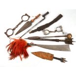 A collection of various bladed weapons and manacles (9)