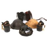 Two British World War Two infantry helmets, together with two childrens' size gas masks.