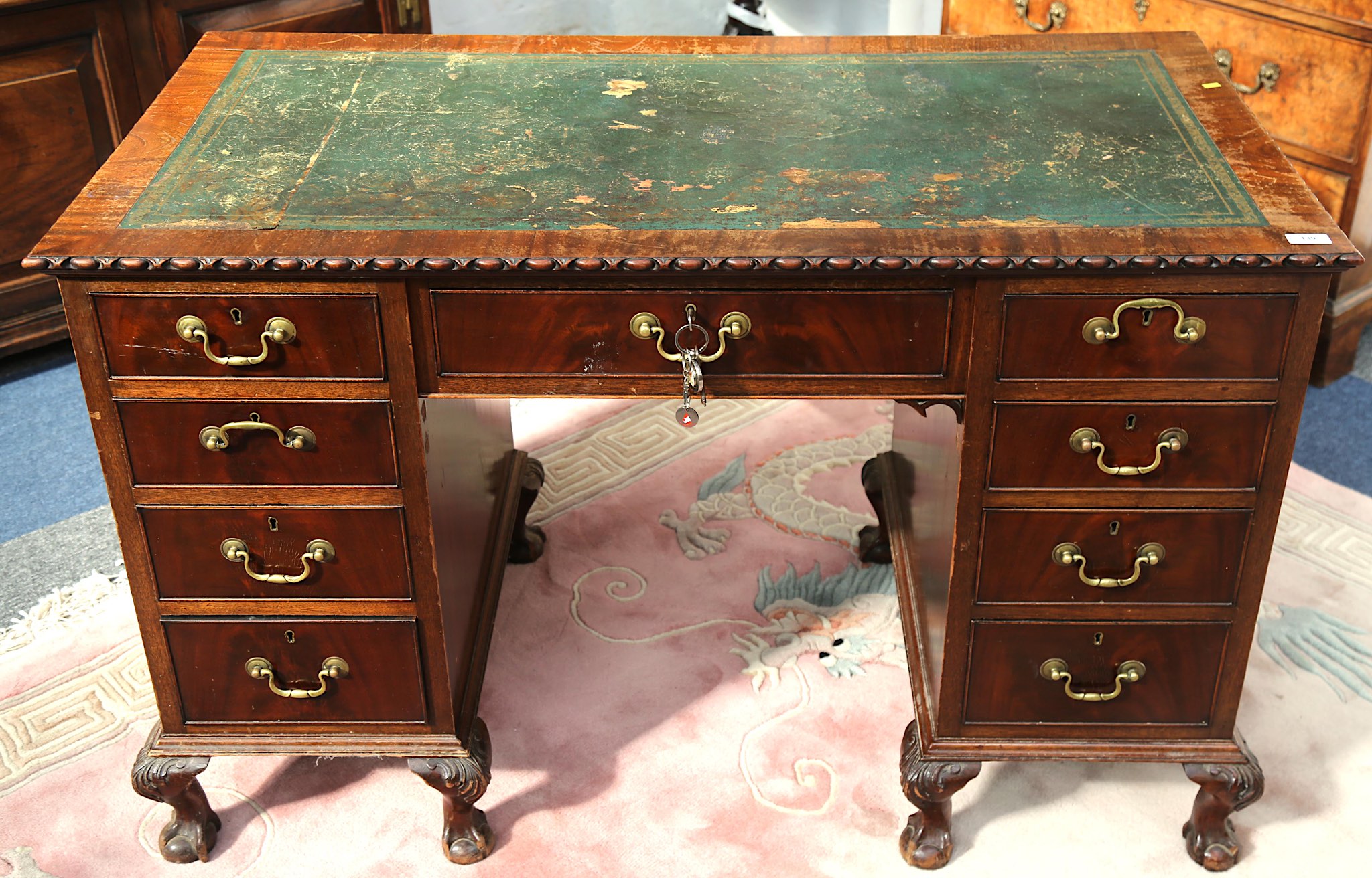 An early 20th Century mahogany writing desk in Georgian style, with twin pedestals on squat cabriole