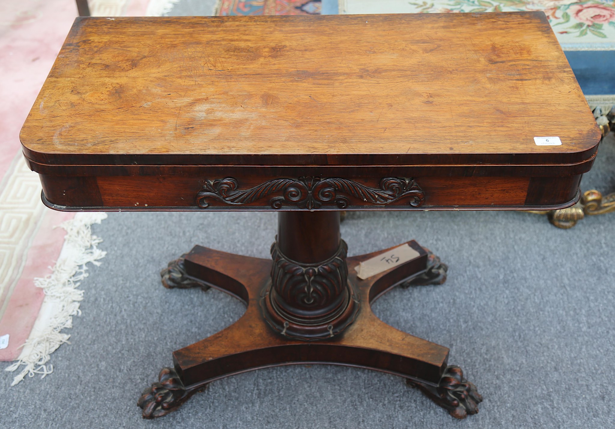 A Victorian rosewood card table, on carved column support and platform base, 91cm wide.