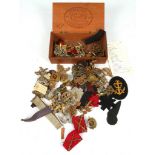 A collection of 20th Century British Military regimental cap and shoulder badges, buttons and