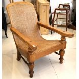 A Dutch Edwardian or later elm plantation / campaign chair, having cane back and seat.