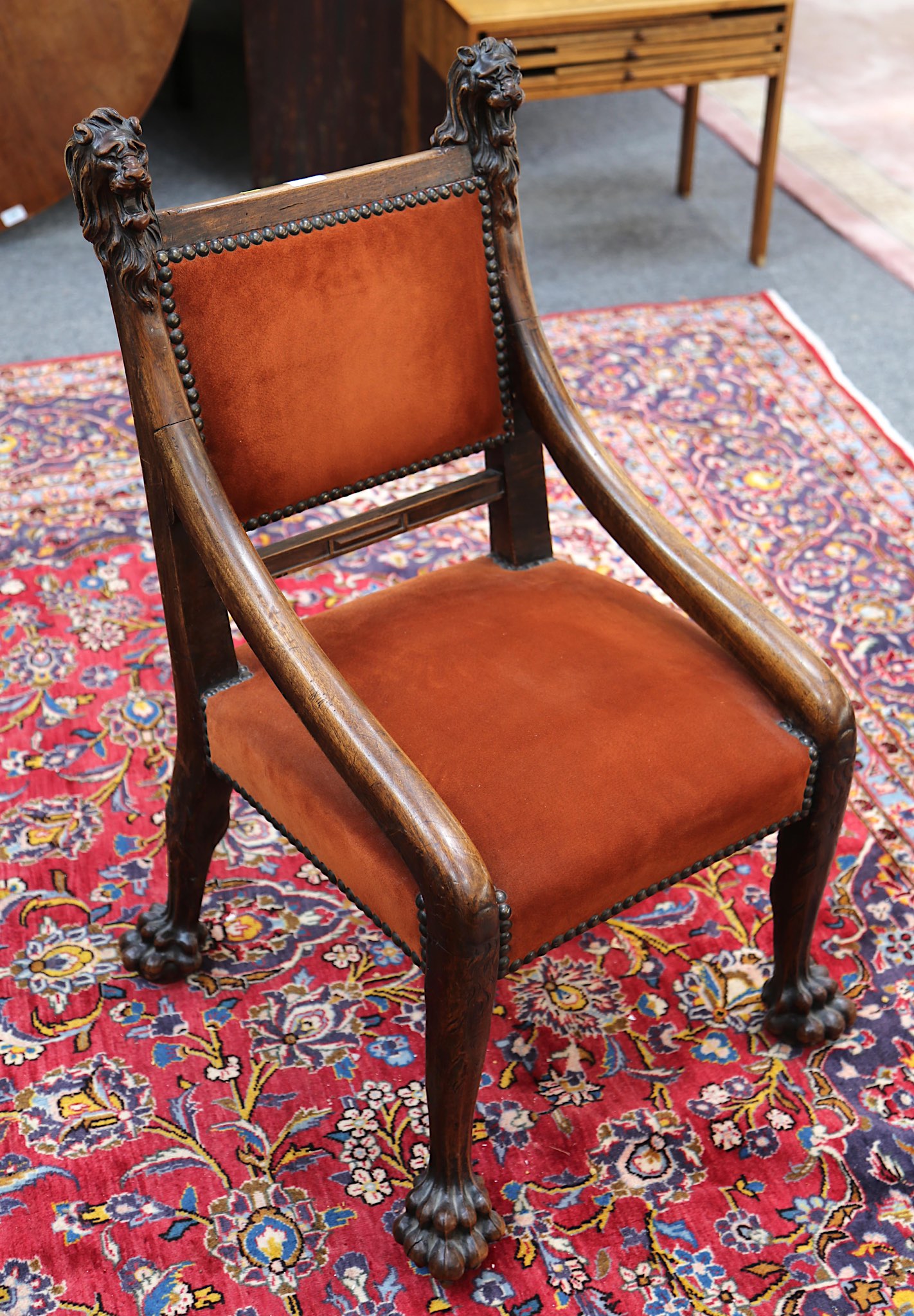 An unusual 18th Century design, walnut side chair, suede upholstered with lion mask finials on paw