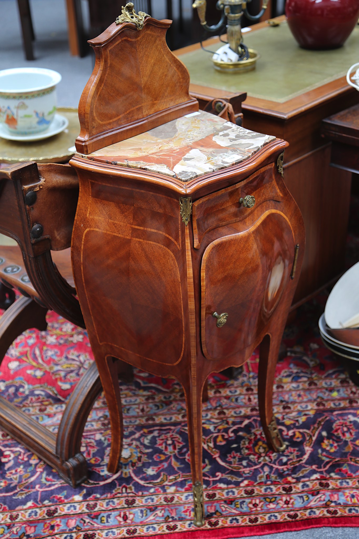 A pair of early 20th Century French, crossbanded mahogany bedside cabinets of bombe serpentine form, - Image 2 of 2