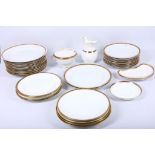 An extensive collection of bone china dinnerware in white with gold rims, having black Greek key