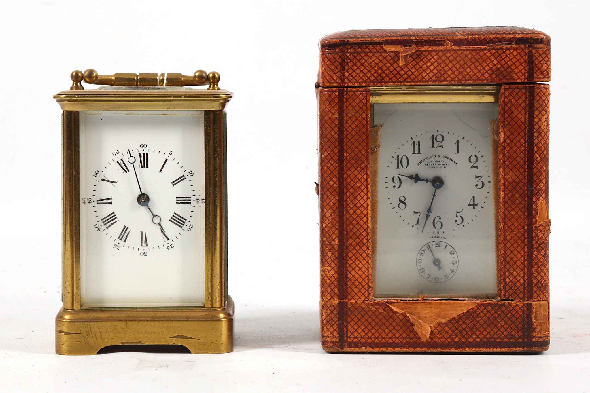 An early 20th Century brass carriage clock, with alarm and leather case, together with another brass