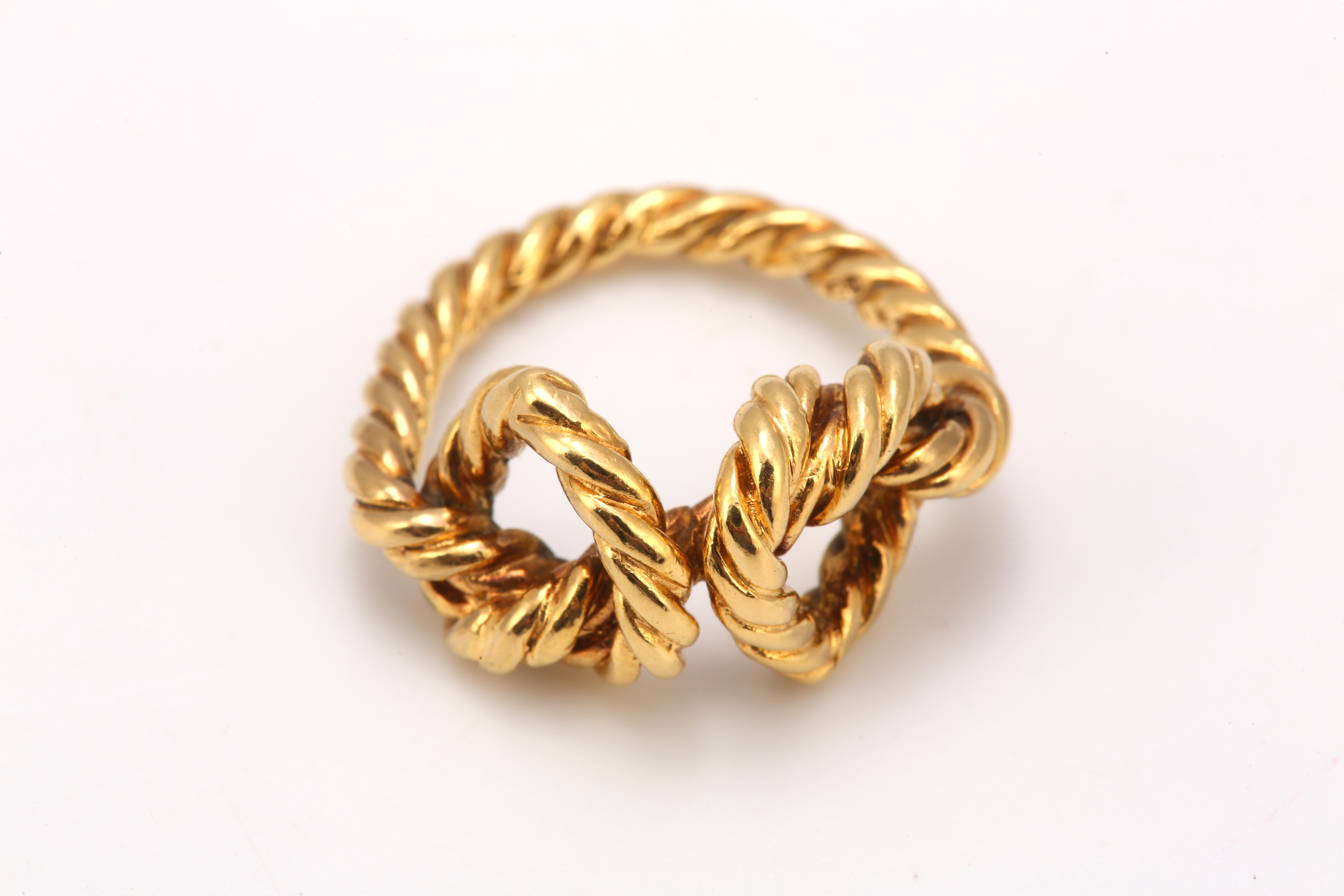 A gold knot ring, The 18 carat gold ropetwist ring featuring two knots, UK hallmark