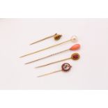 A group of five stickpins, with coral, cultured pearl, citrine, pink paste or micromosaic terminals,