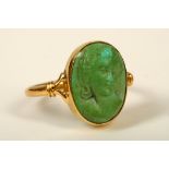 A lava cameo ring, The oval cameo depicting a woman, stamped 750, ring size N, Cameo Corner,