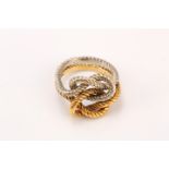An interlocking 18ct white and yellow gold double knot ring, maker's mark JC, UK import mark 1973