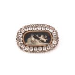 A paste mourning brooch, circa 1875, The oval ivory plaque depicting a woman reclining with a cherub