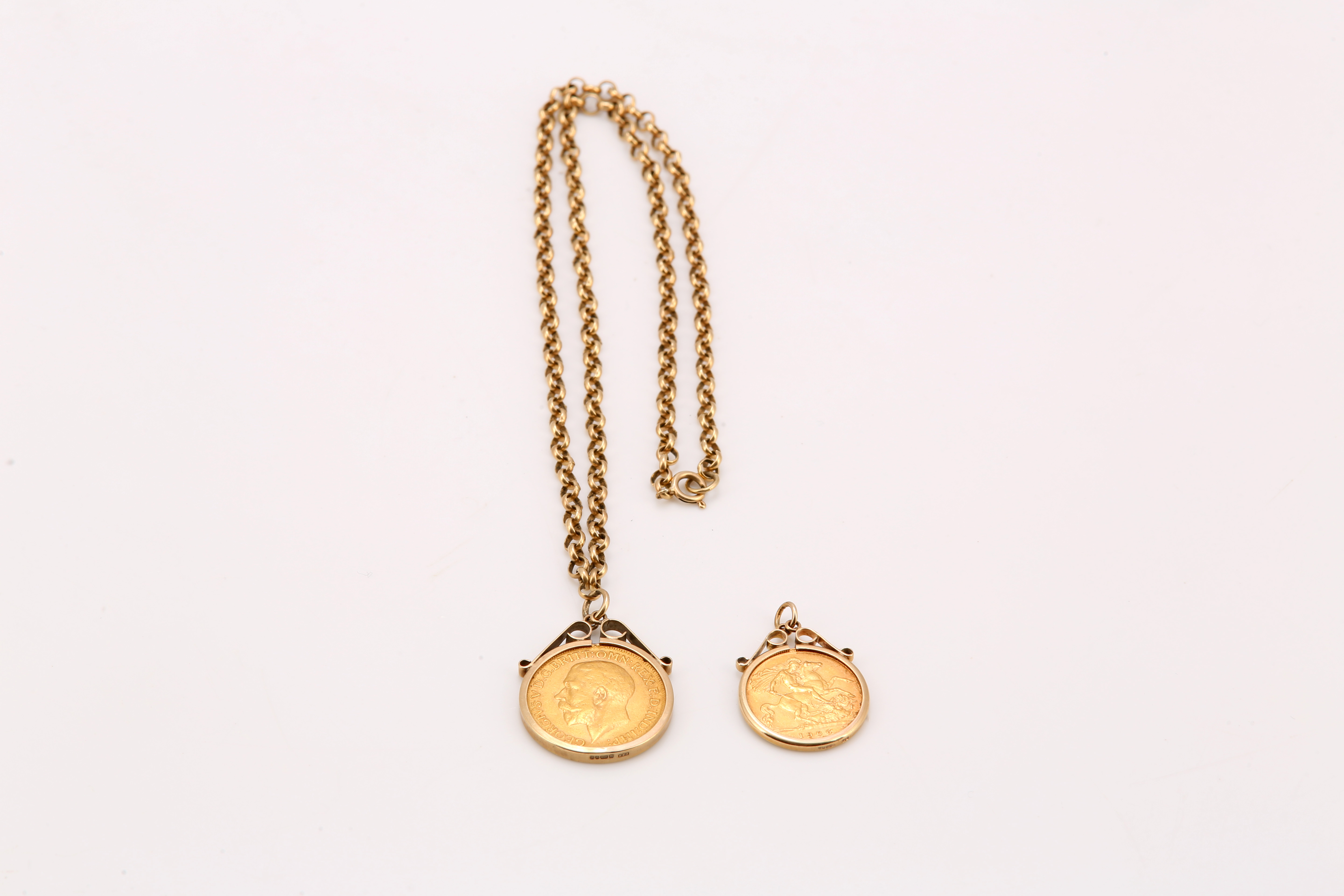 Two coin pendants, each in 9ct gold mount, one half sovereign and one sovereign on a 9ct gold chain,