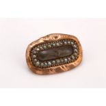 A 19th century hairwork brooch within a half-pearl and snake design surround, length 2.1cm