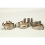 Two Victorian style engraved silver hinged bangles, an Indian white metal bangle and four further