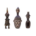 Three African tribal carvings, one with beaded headdress and woven skirt (from Tanzania), and two