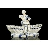 A MEISSEN PORCELAIN FIGURAL SWEETMEAT DISH, late 19th century, modelled as a young cook wearing a