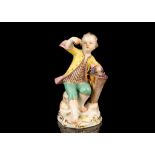 A MEISSEN PORCELAIN FIGURE OF A BOY HOLDING GRAPES, late 19th century, after the original model by