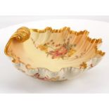 A ROYAL WORCESTER PORCELAIN BLUSH IVORY SHELL SHAPED BOWL, dated 1896, with a gilt scroll handle,
