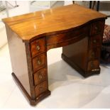 George III serpentine front mahogany kneehole wring desk, fitted two central drawers flanked by