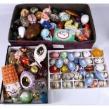 A quantity of decorative panted eggs in various materials, wood, porcelain etc, mostly European