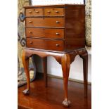 A 19th Century miniature chest of two short and three long drawers, raised on a cabriole legged