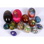 A small group of Chinese cloisonne enamelled eggs in various colours and sizes, sold together with a