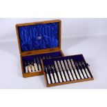 A cased set of 12 hallmarked silver and mother of pearl dessert forks and knives, by Goldsmiths &