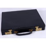 A vintage Asprey black leather briefcase, combination locks with pigskin interior.