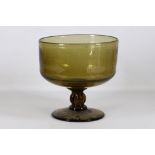 A large green tinted glass footed goblet or punch bowl, with a generous bucket-shaped bowl on a