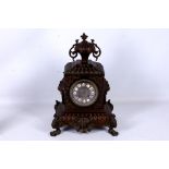 A late 19th Century French bronze metal mantel clock, the gadrooned lion mask case with circular