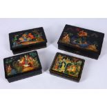 A set of four various 1970's Soviet Russia paper mache Palekh lacquered presentation boxes. All